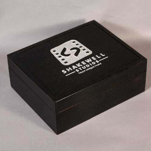 ebonized box with silver leaf like text