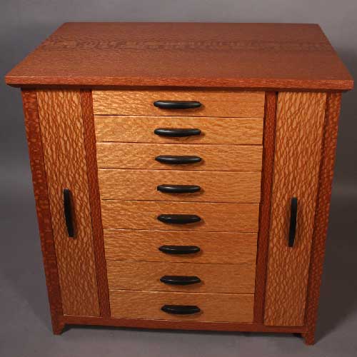 This is a picture of the back of the box. All of the pieces are made of solid koa and tongue and grooved together. The whole panel is put on with solid brass screws to allow you to remove it if necessary.